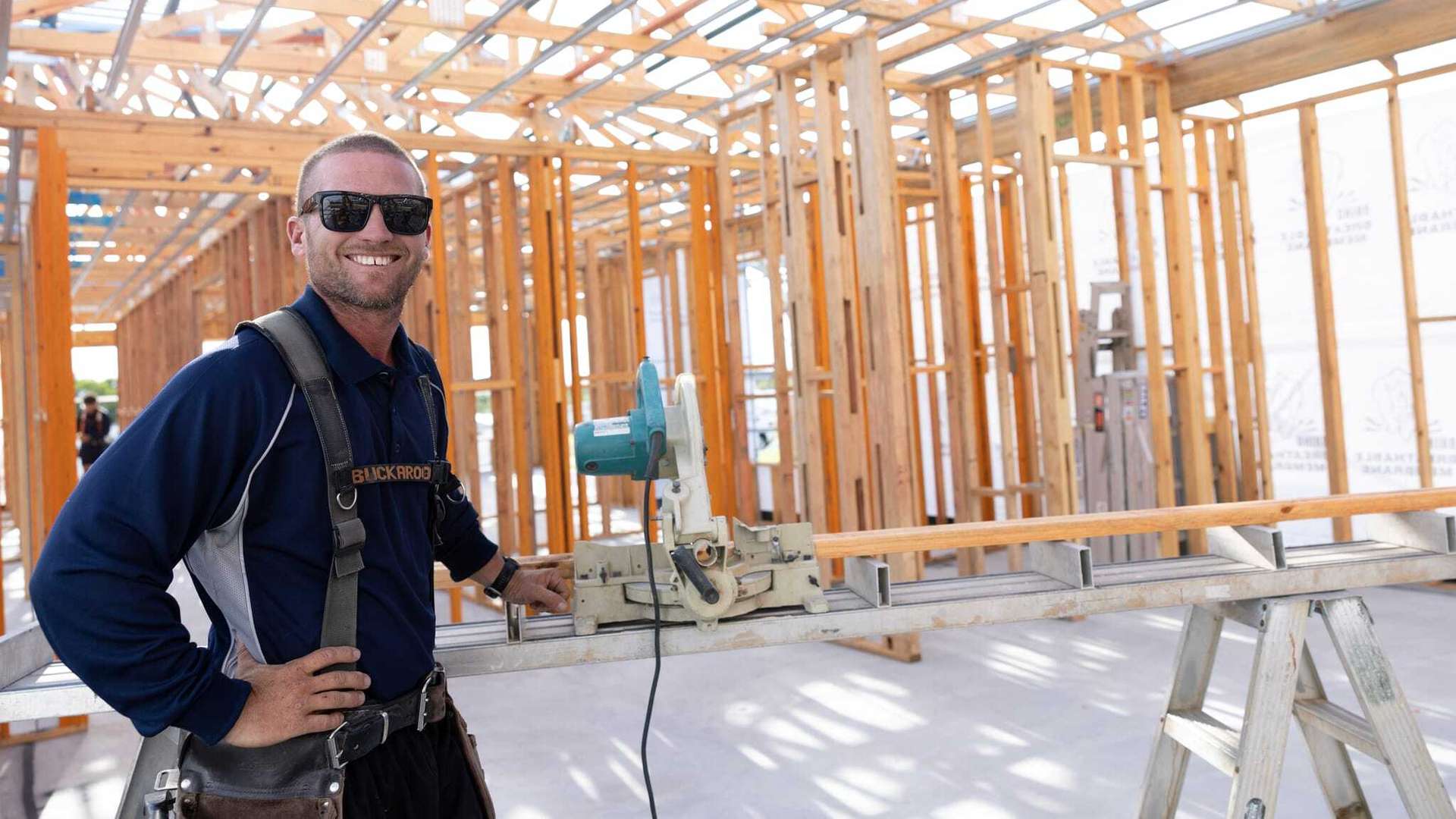 Building and Construction student standing on a construction site of a house