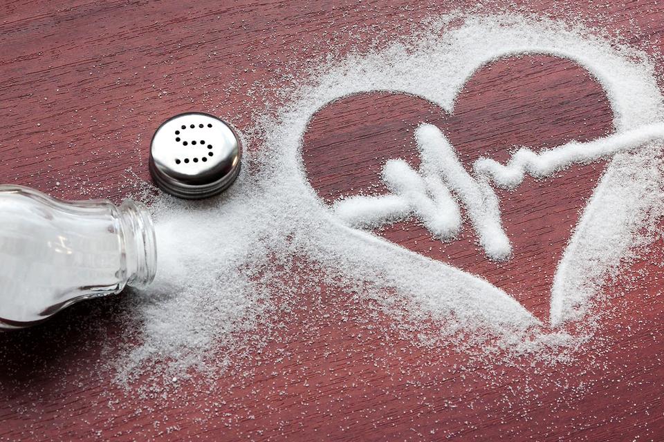 Spilt salt that has been shaped into a heart with a heart beat in the centre