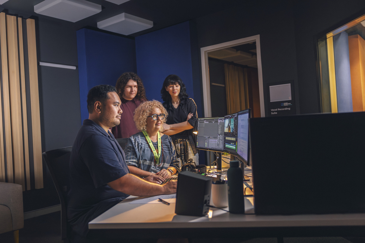 CQU staff member working with crew behind the set of a film set