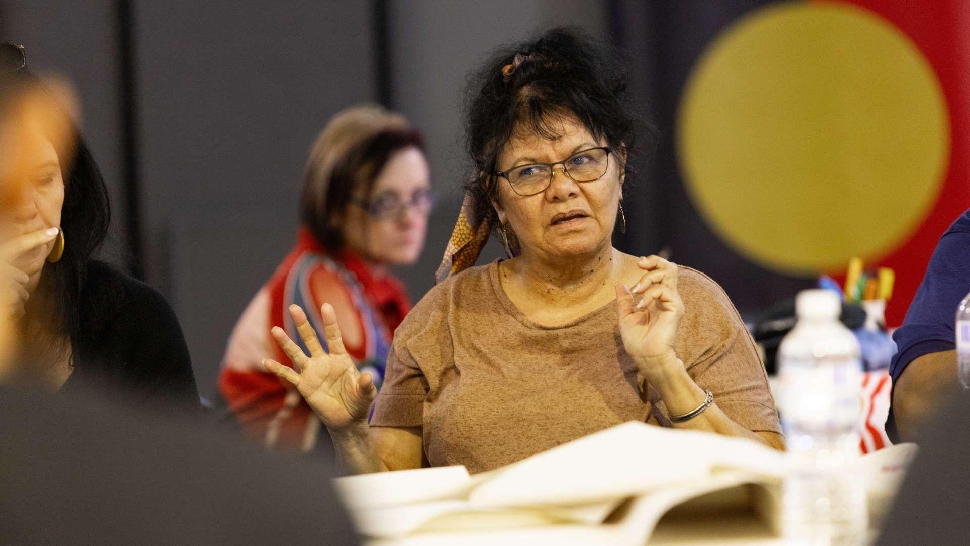 A person sitting at a table during a group discussion.