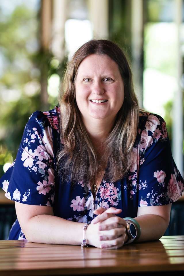Alumna Shelly Coombs wearing a floral blouse