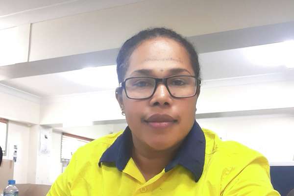 Sophie Sindra Hepota wearing a high vis shirt sitting in a classroom