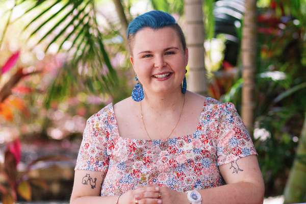 Rhiana Jackson sitting at a table outside in a garden