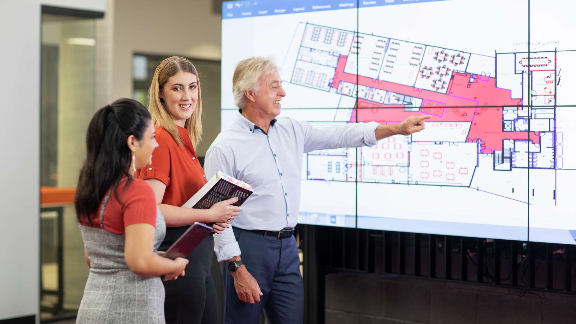 Building Design students staring at an architectural design on screen.