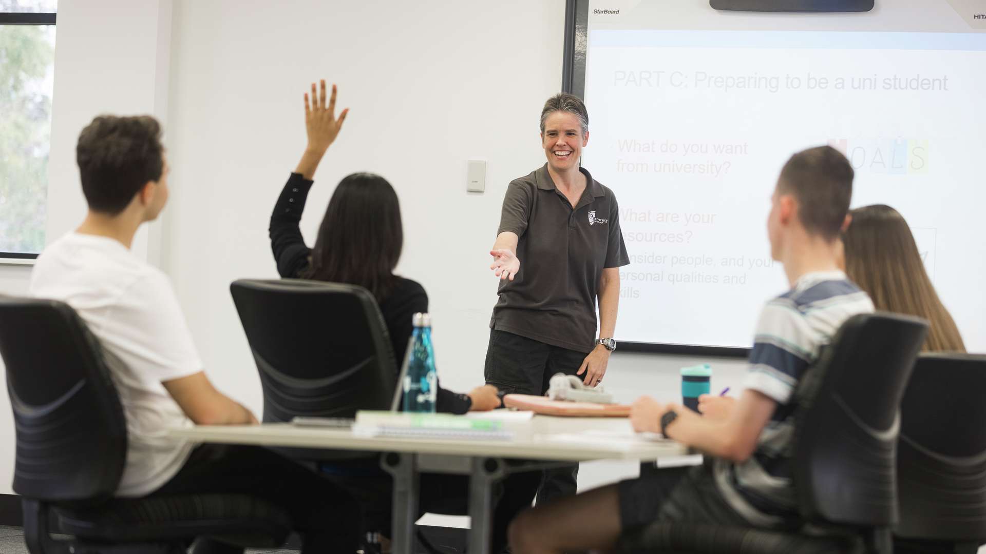 A STEPS teacher calling on a student with their hand raised in class