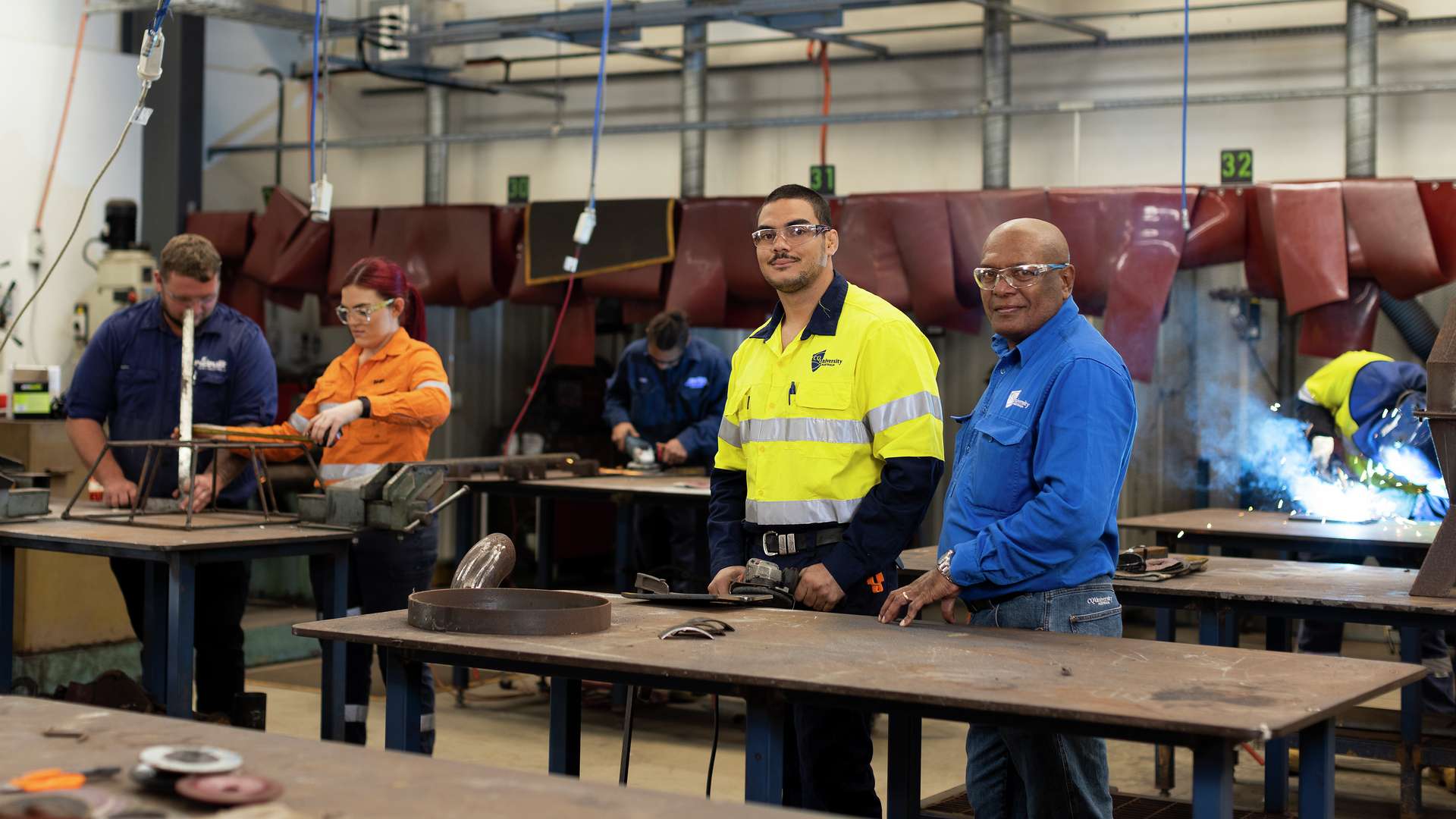 A First Nations trades student with their tutor in a workshop