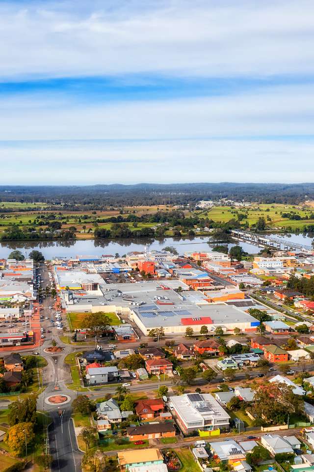 Aerial view towards Martin bridge over downtown streets of a Taree local rural town on Manning river in Australia NSW.