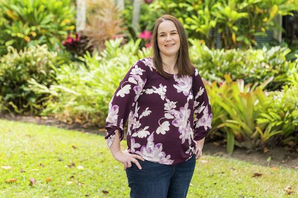 Tracey Dangaard smiling at the camera standing in a garden