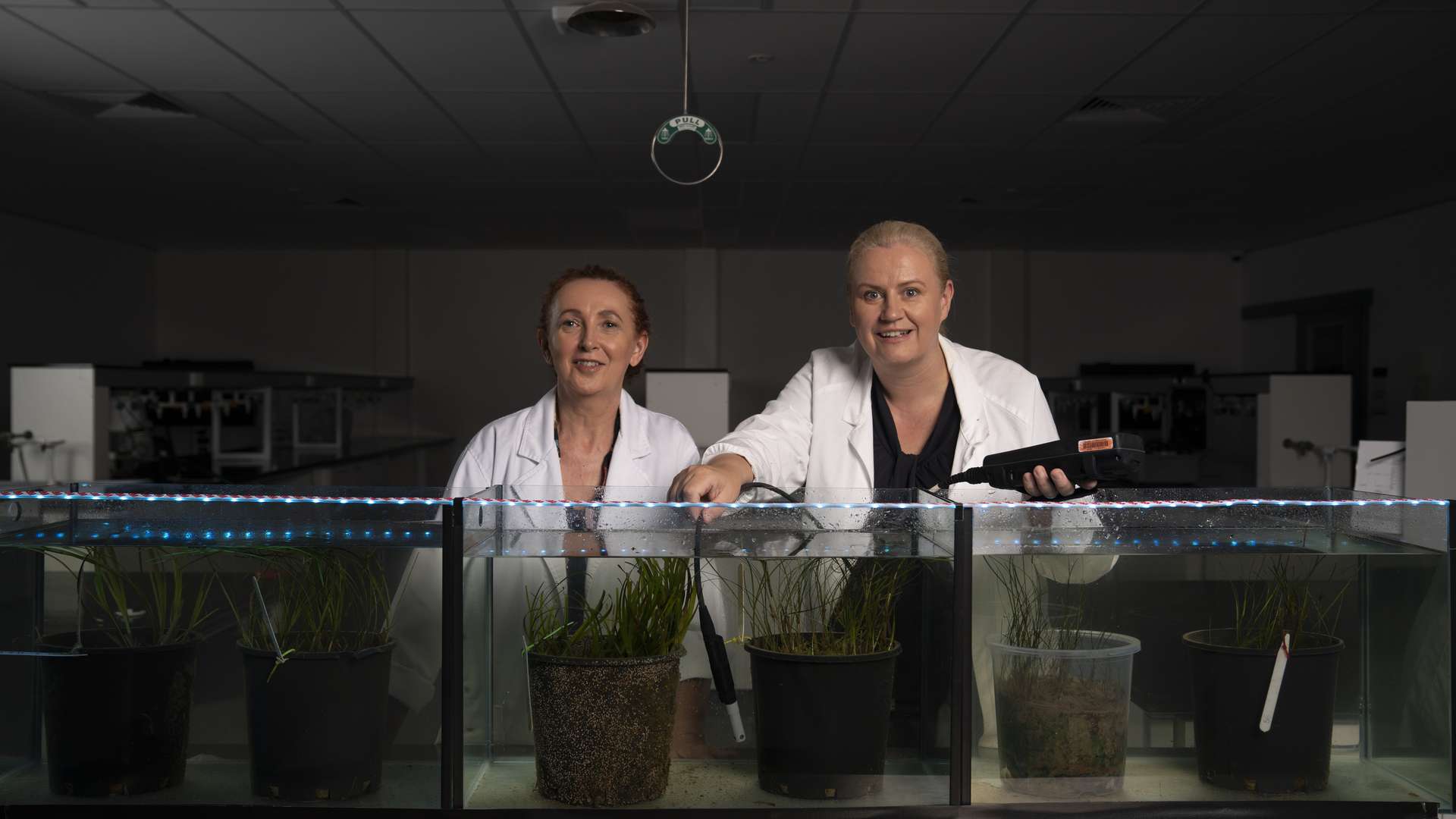 two researcher students testing plants