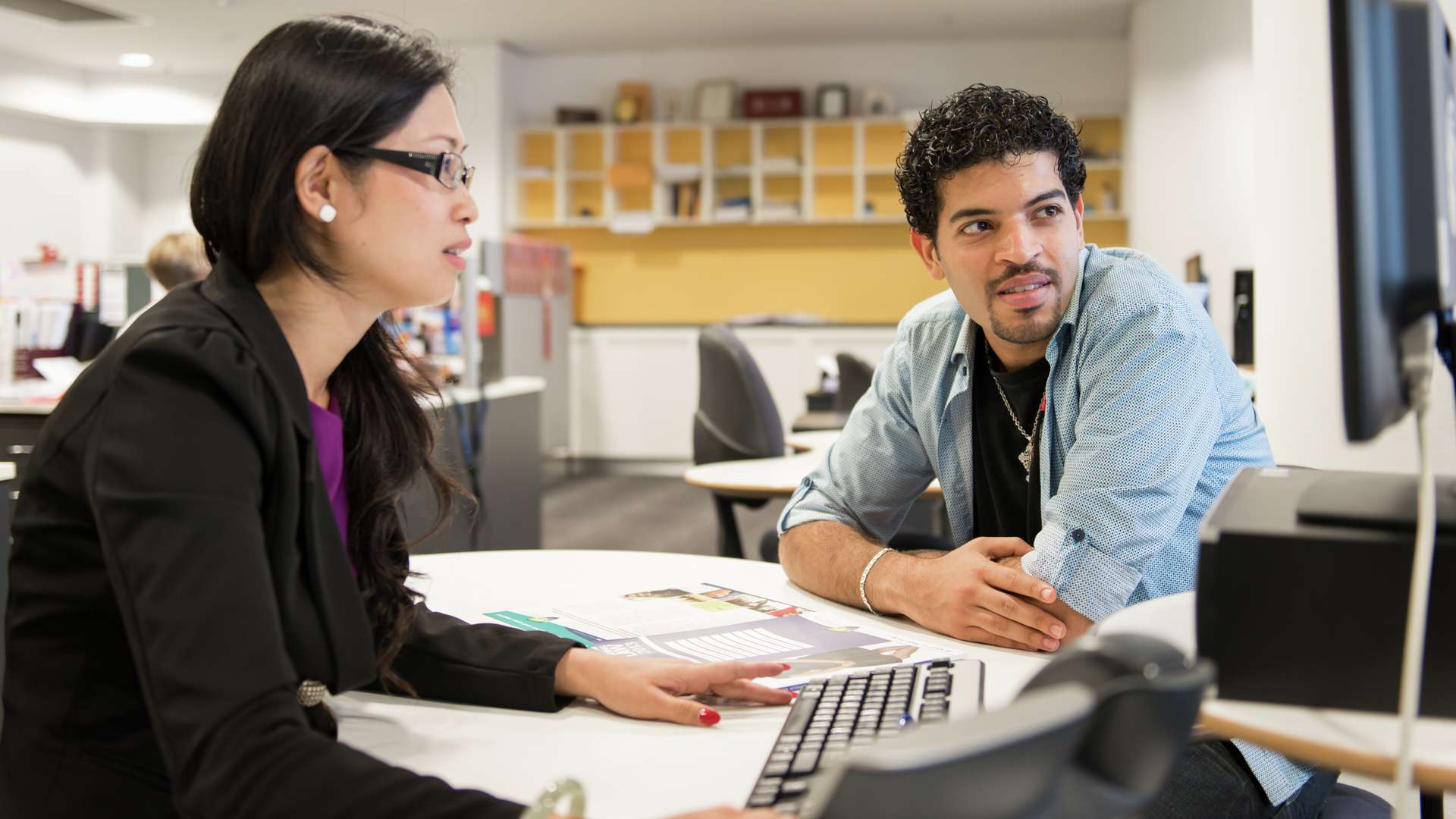 Two students studying together in the library