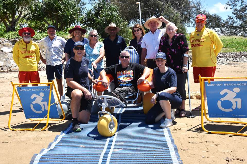 Representatives from CQUniversity and U-BEACH, Emu Park Surf Life Saving Club, Livingstone Shire Council and Spinal Australia test beach accessibility equipment on a beach.