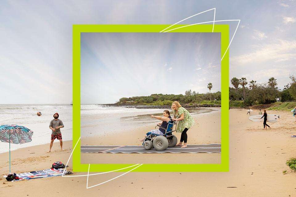 An image of a beach is overlaid with a framed image of Sasha Job and Krystal Perger in a wheelchair, on an accessible beach pathway.