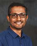 Head shot of Varun Chandrappa smiling