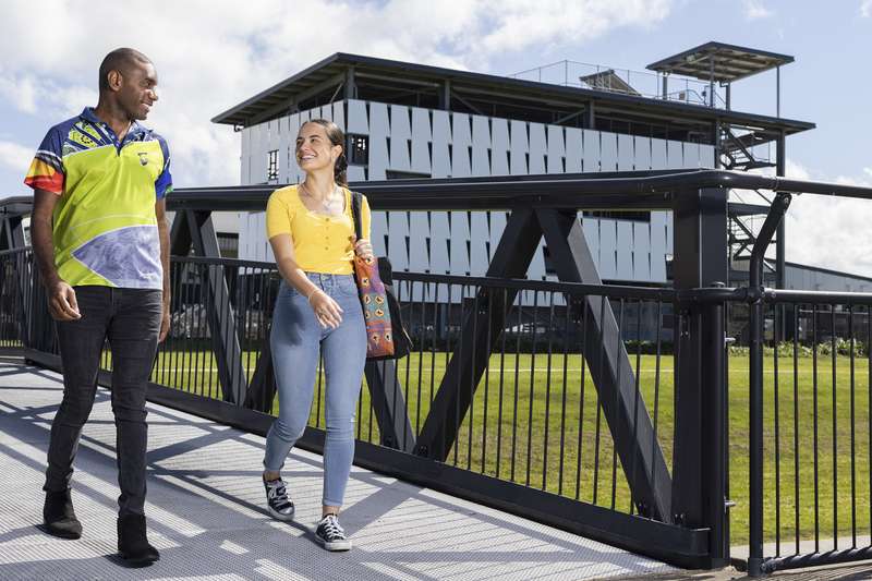 Two First Nations students walking together outside Mackay campus